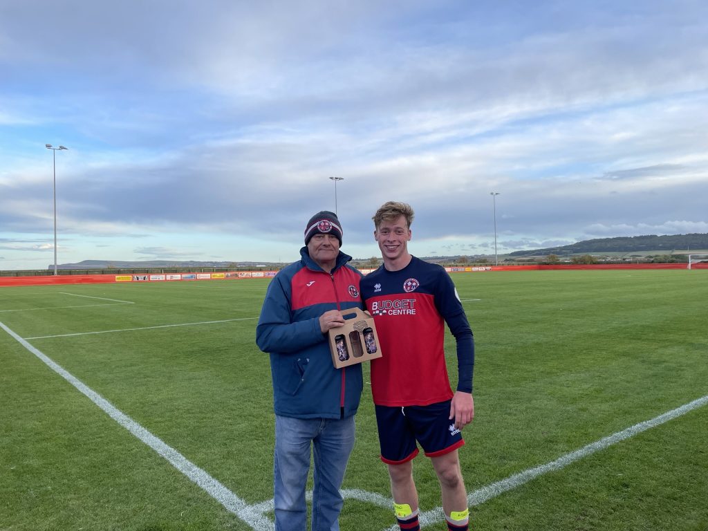 Isaac Walker, right, collecting a man of the match award.